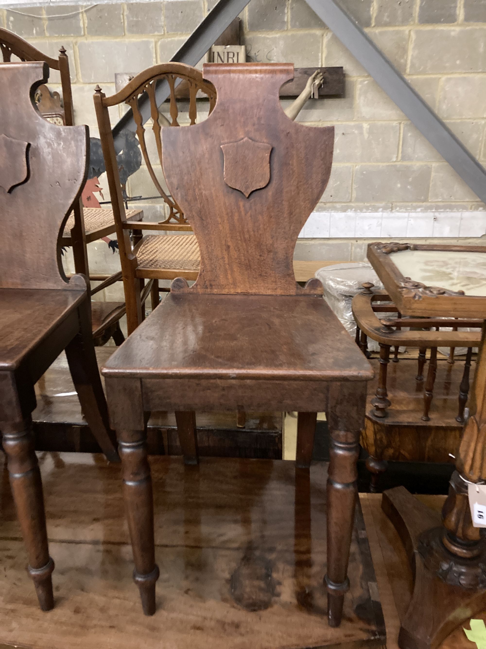 A pair of Victorian mahogany hall chairs